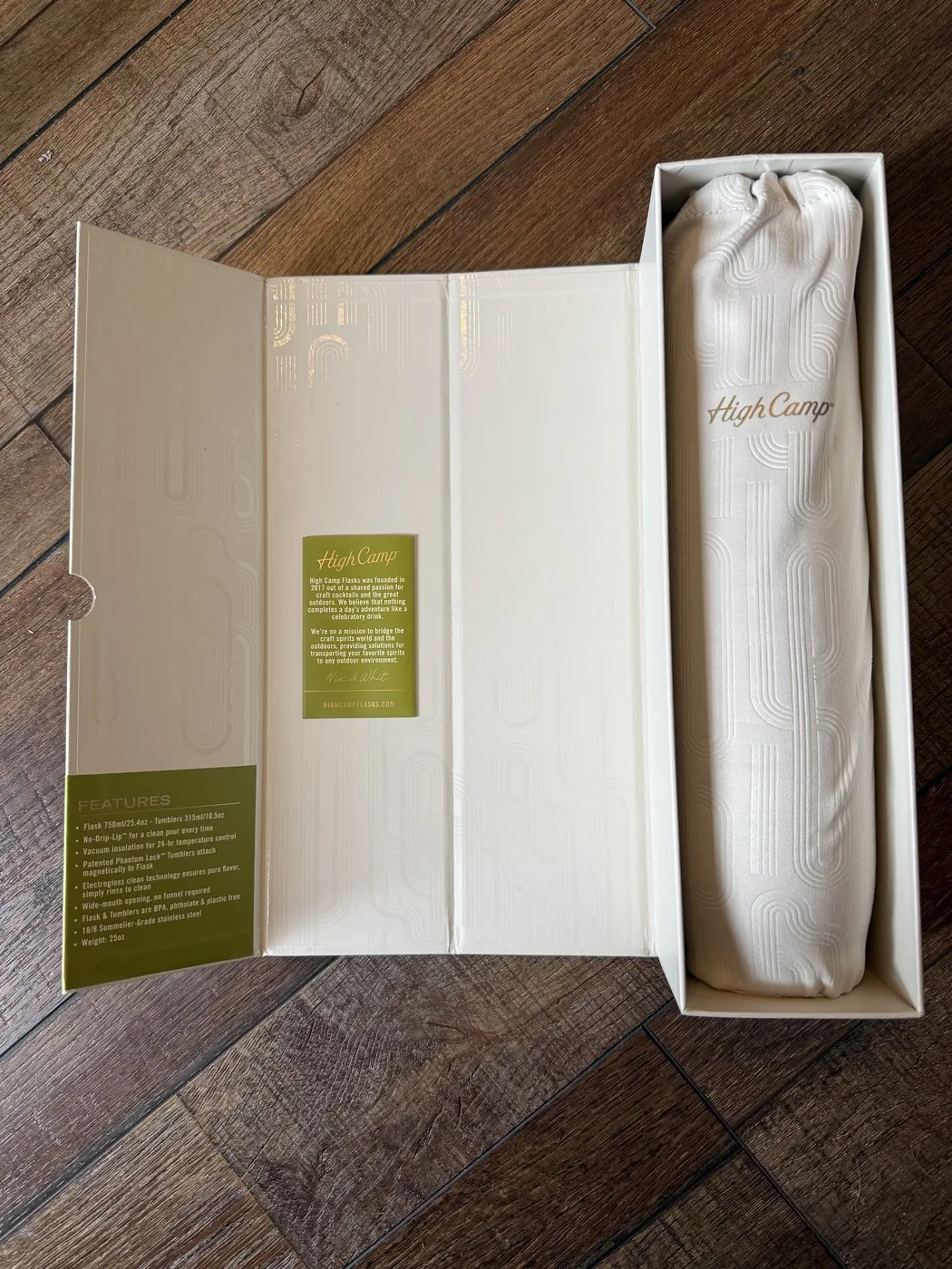 High Camp Vintage Spirits Parkside Flask unboxing — flask wrapped in a fabric dust bag embossed with the geometric Artist Edition engraving pattern