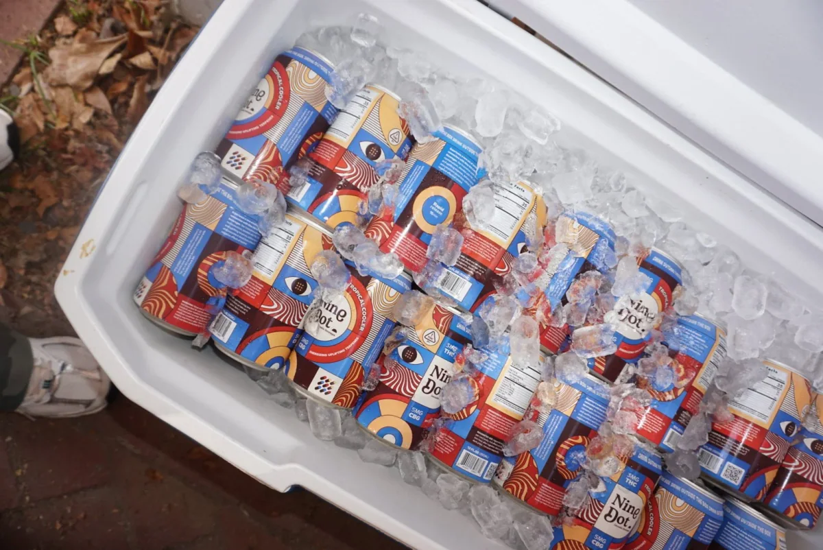 Nine Dot Cannabis Beverages cans iced down in a cooler — the format Spang built for the bar-and-restaurant alcohol-alternative occasion