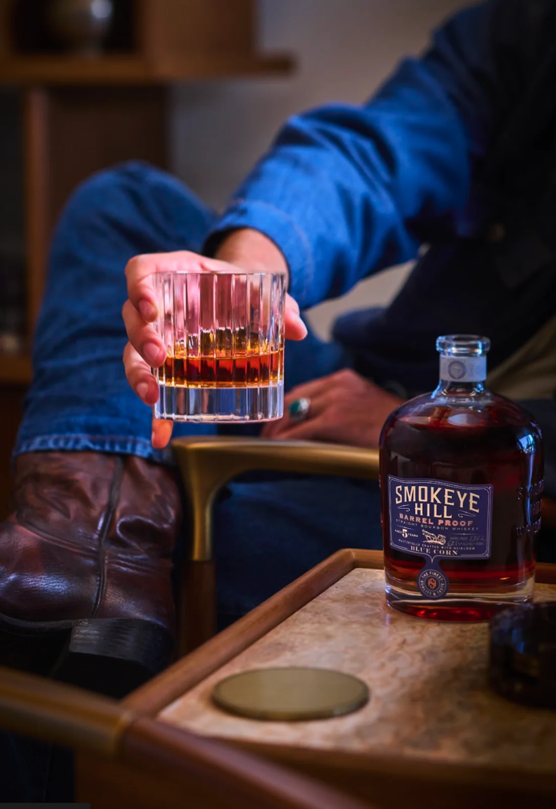 A pour of Smokeye Hill Barrel Proof blue-corn bourbon beside the bottle